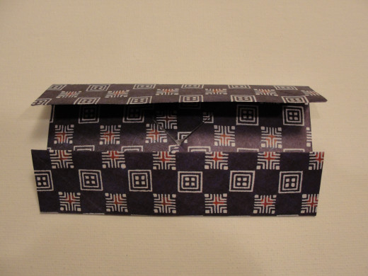 Fold both ends, then do the same on the shorter ends to form a square.