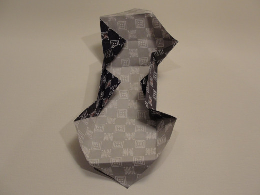 Fold one corner inward, and repeat on all four corners.