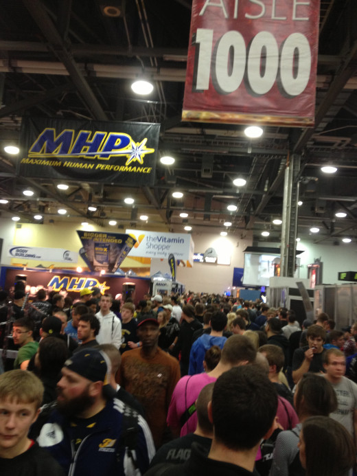 The crowd and a sample isle and vendor signs.
