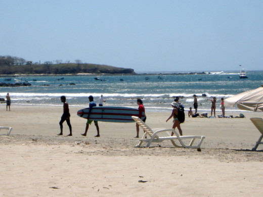 A paddle board being toted across Playa Tamarindo.  Tamarindo is popular with surfers and it has an estuary where there are tours.