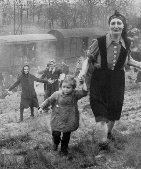 Jewish refugees, approaching allied soldiers, become aware that they have just been liberated, April, 1945.