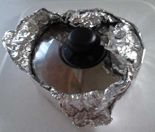 Fold the foil back down over the edges and tuck it under the bottom and remove the shaping item you used.