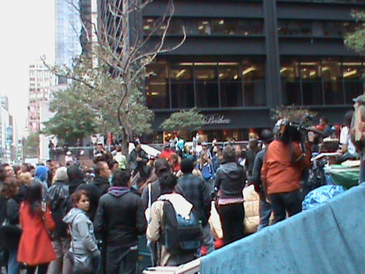 Crowd gathering to watch spontaneous, and completely pointless, episodes of semi-naked dancing during an Occupy protest.