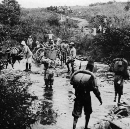 Belgian troops of the Force publique crossing a stream in what was then the Belgian Congo.  A long history of strife and exploitation has been suffered by this region.