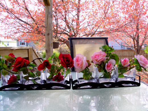 Glass vases and faux silk roses to add color and grab attention. Livens up a kitchen shelf.