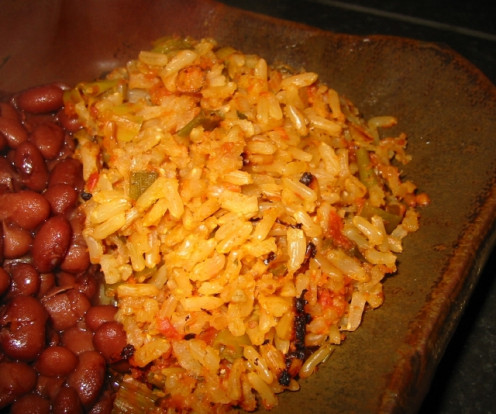 Adding kidney beans as a side dish to spanish rice.