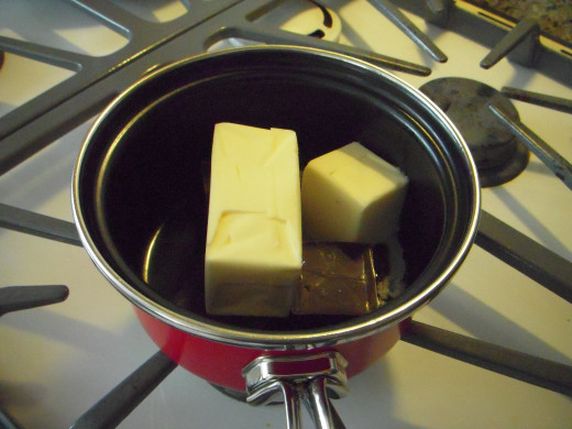 Place butter and chocolate together in a small pan over very low heat. You will need to watch and stir constantly to ensure the chocolate doesn't burn and curdle.