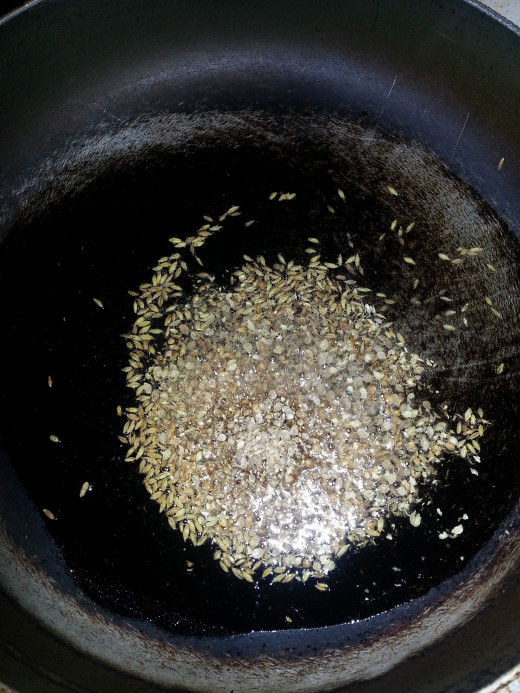 Add coriander and cumin seeds to hot oil