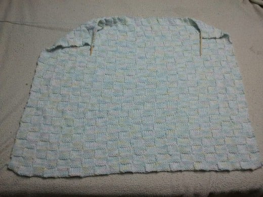 This baby blanket is my current project. I have spent $10 on yarn and two weeks of my excess time. It is nearing completion and should be ready for the baby shower. 