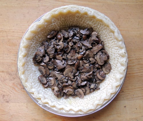 layer veggies into pie shell, starting with mushrooms