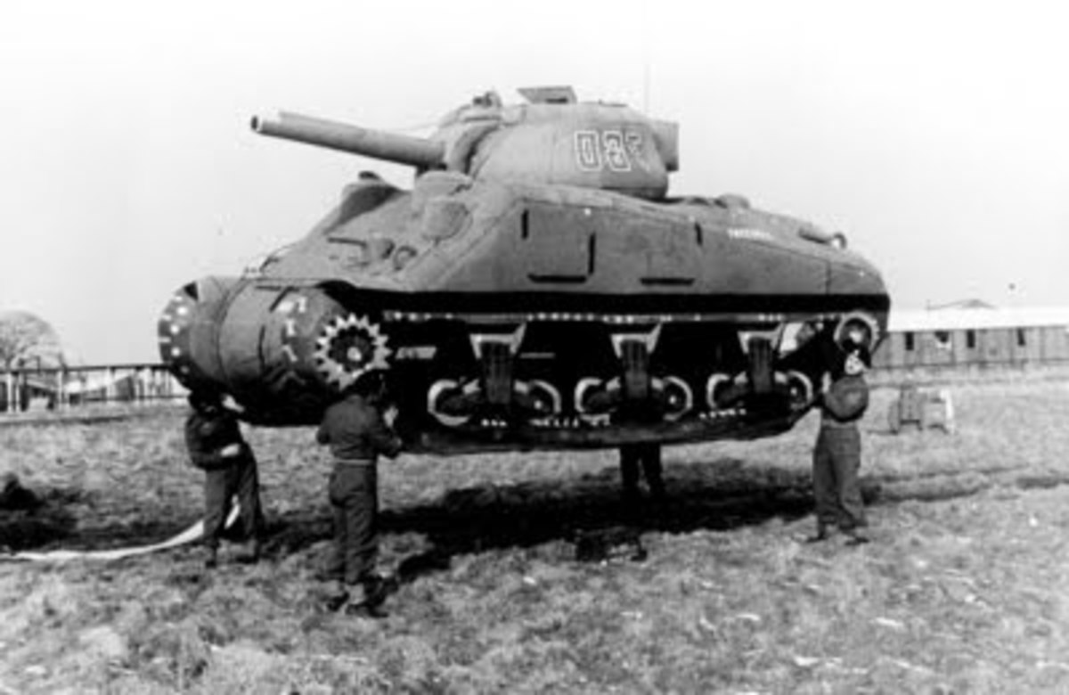 Four men lifting an inflatable tank