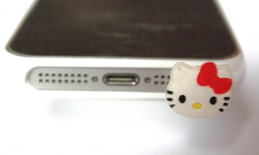 A Hello Kitty dust plug protects the earphone jack on an iPhone. Functional, but also fashionable 