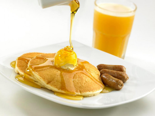 How about pancakes and syrup with sausages on the side, along with a fresh mango shake? It's the perfect way to really rise and shine!