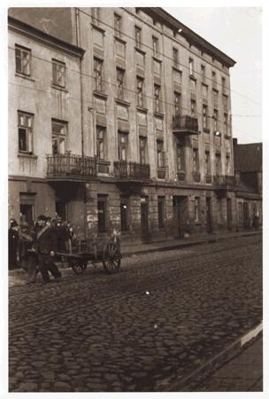 This is from Ghetto Litzmannstadt: Men haul a cart down the street.  