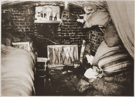 A man comes out from a hiding place that was created for the Warsaw Ghetto uprising.  This happened many times over, and makes me think of Corrie Ten Boom's, The Hiding Place. 