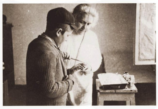 Woman doctor in a ghetto helping a young man that injured his hand.