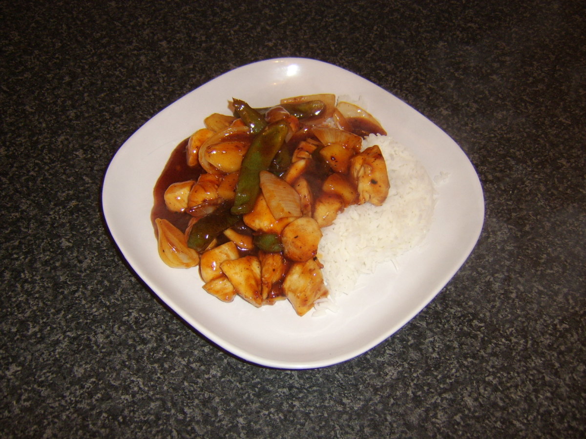 Sweet and sour chicken with boiled rice is ready to eat