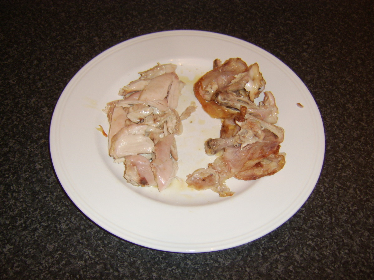 Skin is removed from the chicken thighs and meat plucked from the bones