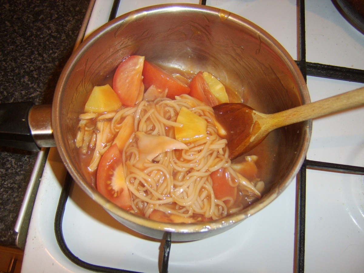 Tomato and pineapple are added to sweet and sour sauce