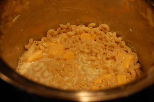 cheeses, milk and spices added to cooked macaroni