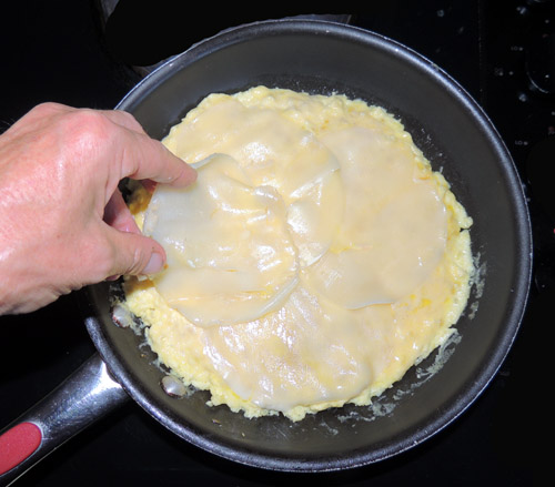 once mixture is somewhat set, layer provolone slices