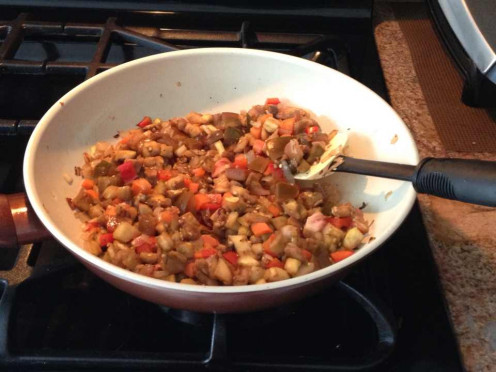 Cooking the stuffing for the baked eggplant - eggplant, red bell pepper, onion, carrots, Kumato tomatoes