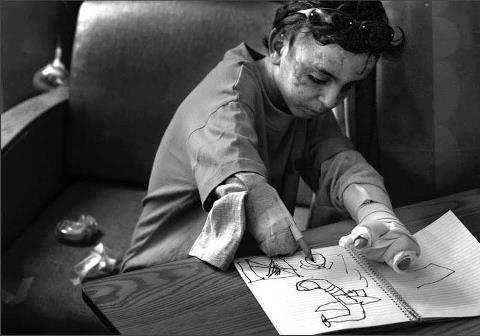An Iraqi boy draws the war planes that bombed his house, killing all his family members, and injuring him.