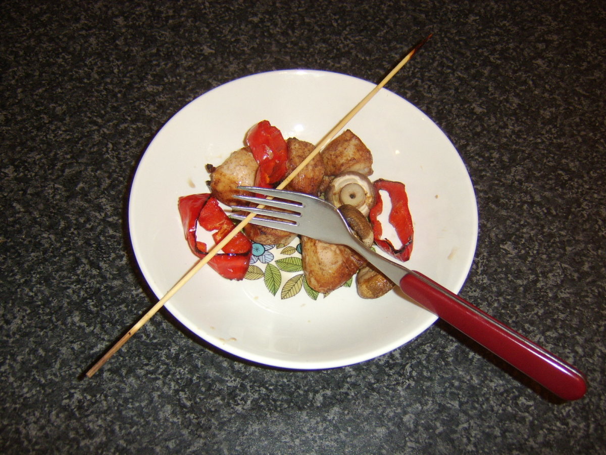 Chicken and vegetables are slid from skewer