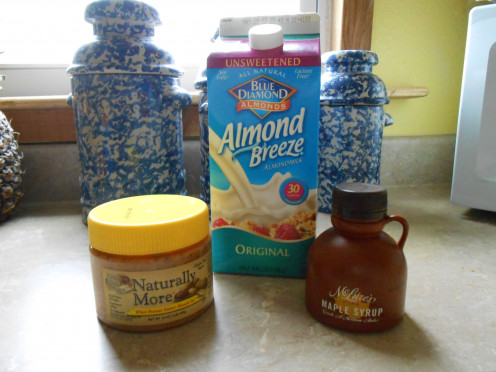 Natural peanut butter, almond milk and pure maple syrup are foods that can be enjoyed on a vegan diet.