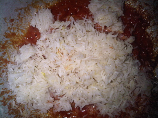add rice to tendered tomatoes