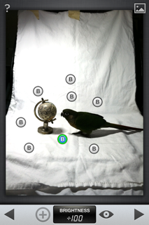 Snapseed is a great app for the "selective adjust" tool. Place the brightening circles all around the background.