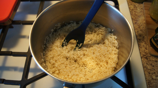 coating the uncooked rice in oil