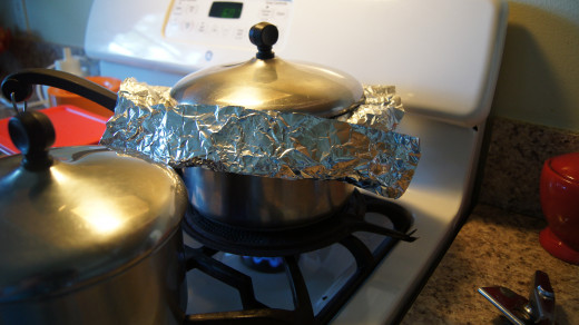 Covering the pot with foil and a lid