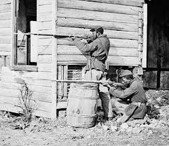 Two soldiers taking careful aim, this picture looks somewhat staged, but could be rel.