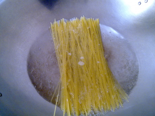spread the raw spaghetti across the boiling water