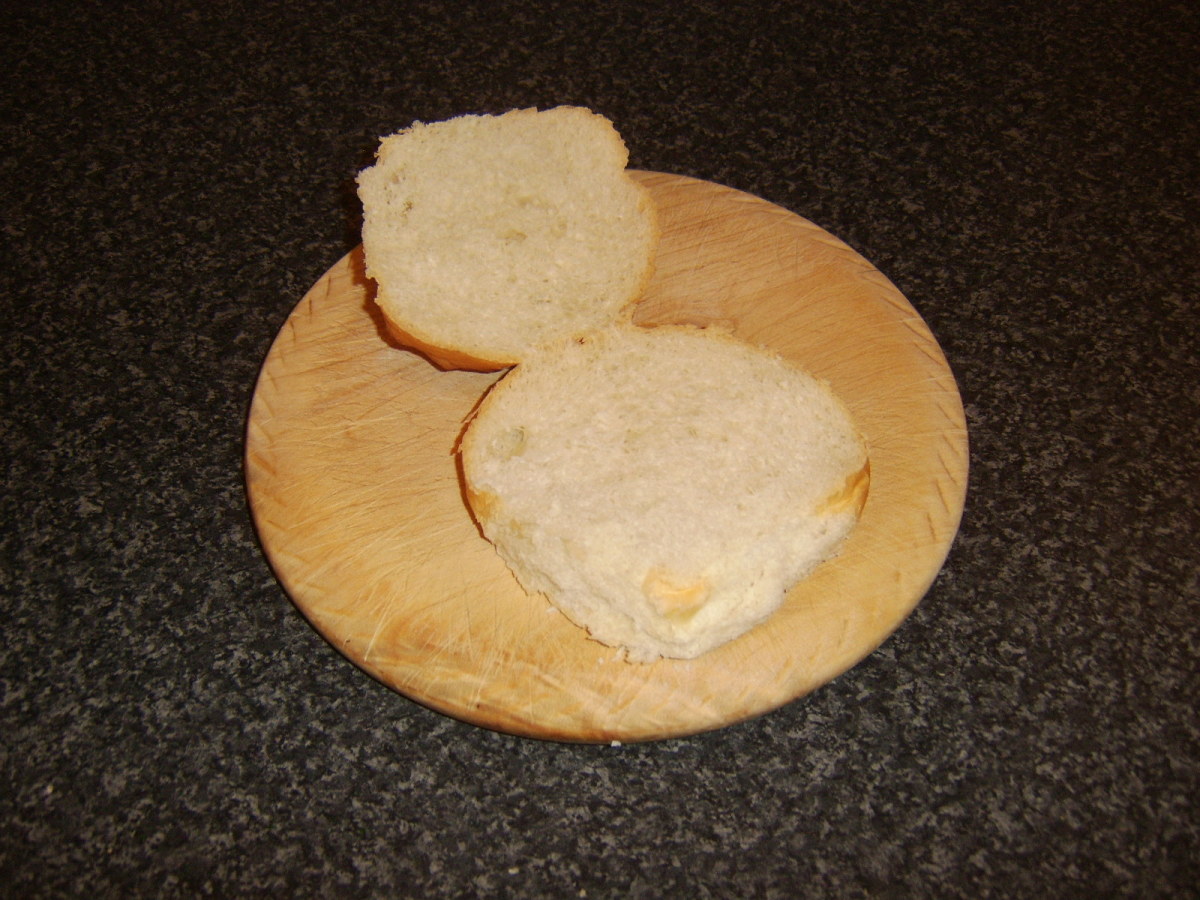 Bread roll is halved for assembling sandwich