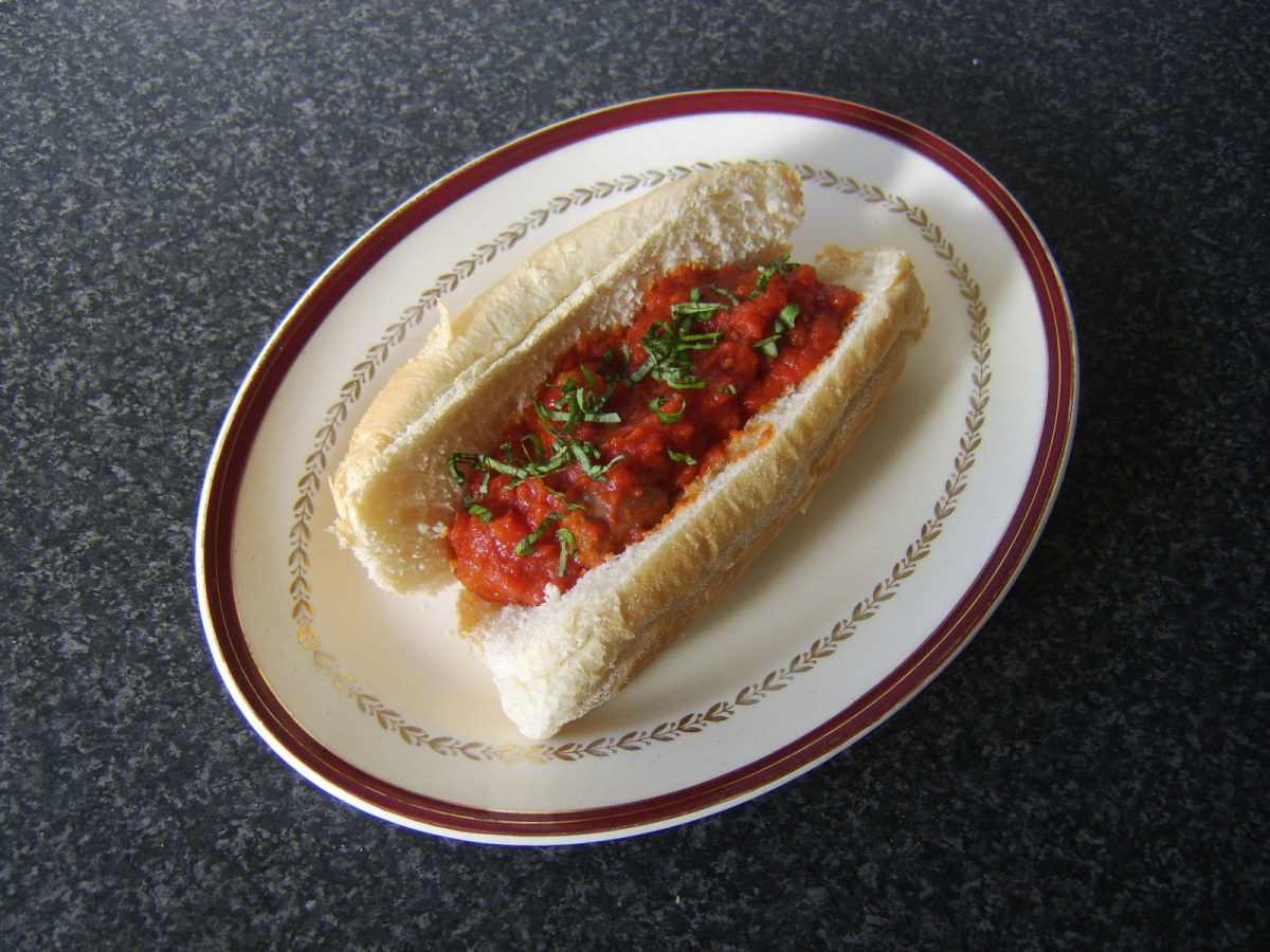 Beef sausage pieces in a hot and spicy tomato sauce in a sub roll
