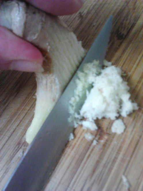 This is my chunk of frozen ginger root that I shave into a fine powder pile within seconds using a serrated blade.