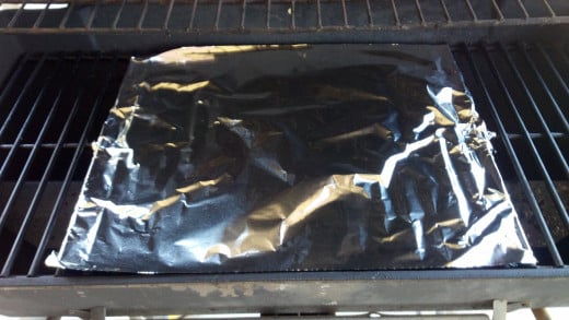 Aluminum foil on grilling rack.
