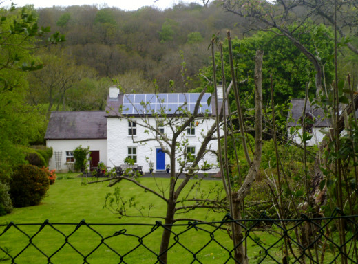 A farm house through the trees.An almost romantic aura.