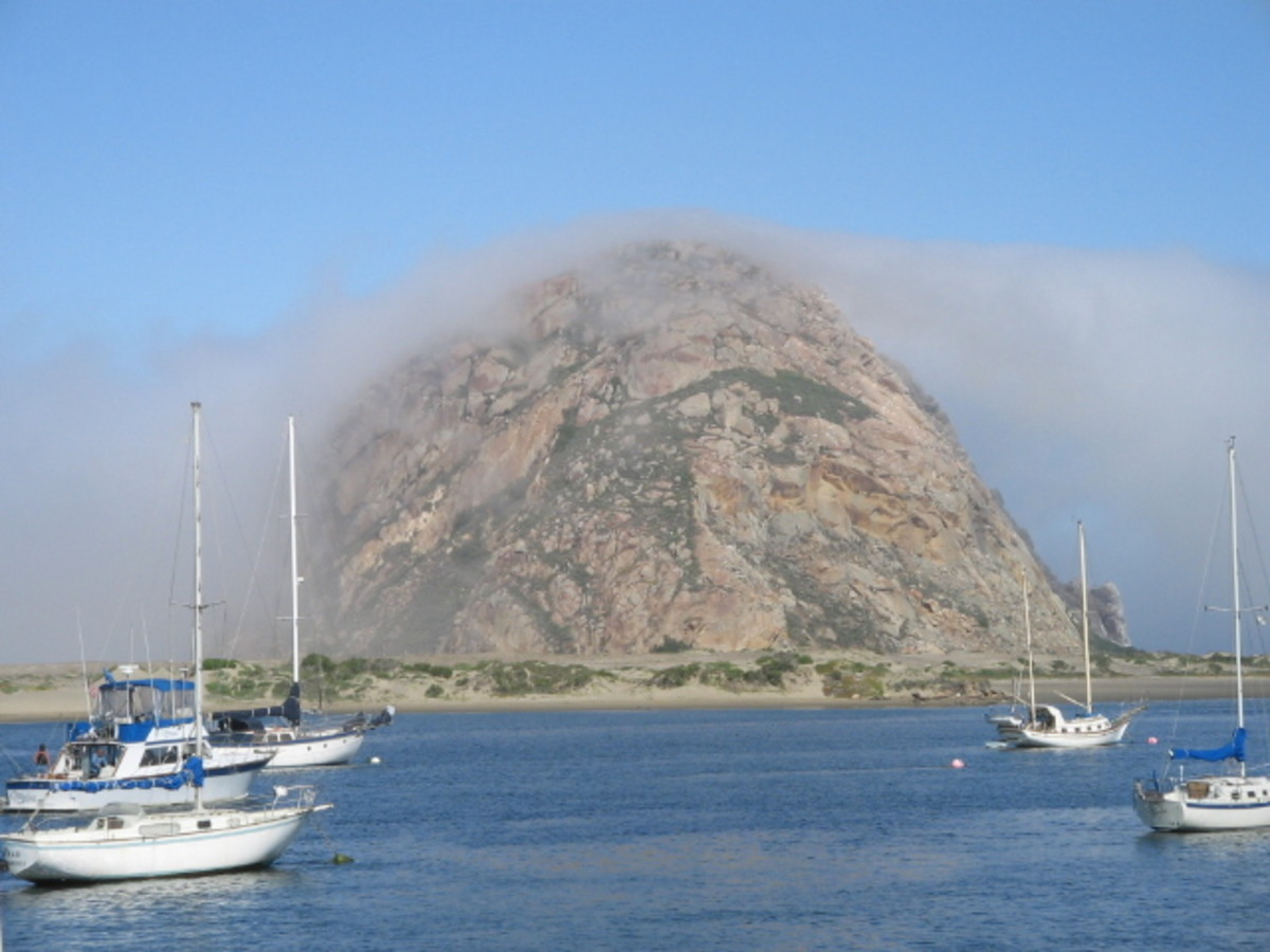 Morro Rock covered in a layer of fog.