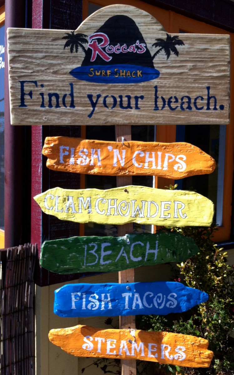 A sign outside of another restaurant, Rocca's Surf Shack.
