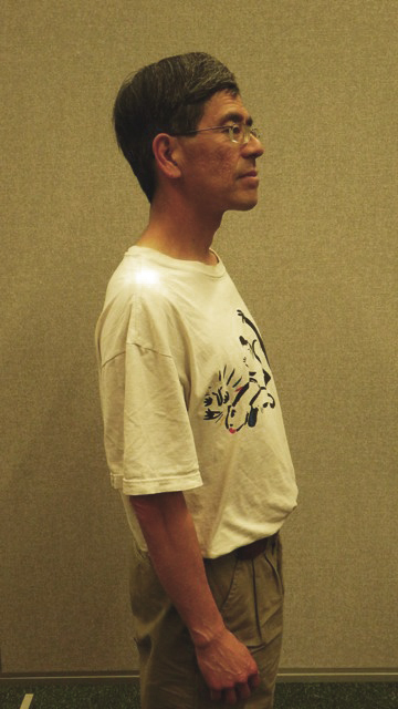 Proper posture - shoulders are back, chest is high, neck and spine are aligned.
