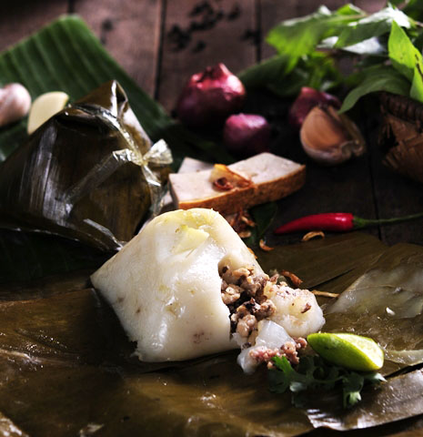hot Banh Gio is traditionally wrapped in banana leaf in a pyramidal shape and to be served with chili sauce or by itself.