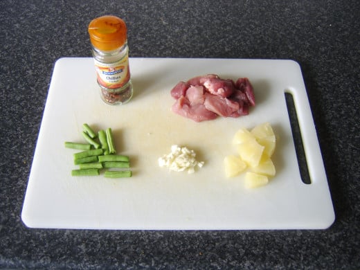 Chopped and prepared ingredients for spicy pork, pineapple and green bean stir fry