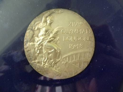 Bill Smith's 1948 Olympic Gold Medal in the men's 400 meter free style. He trained in this natatorium.