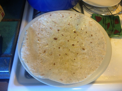 Brush a tortilla with olive oil