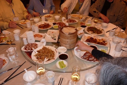 8 d) The round turntable, with Peking Duck and other Chinese foods on it, makes for easy serving