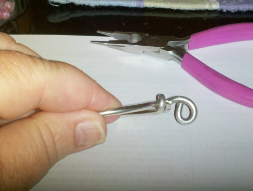 This loop is side facing for stringing with cord or chain.