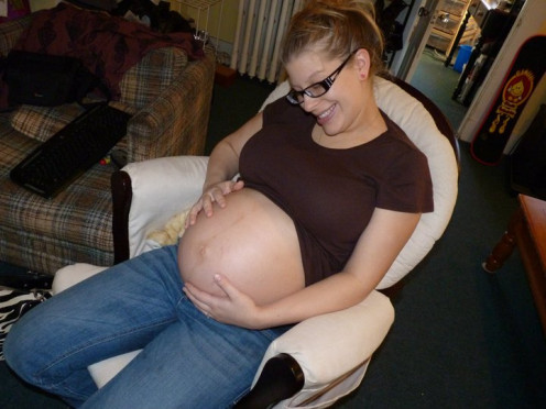 The smile comes from the knowledge that the pregnancy is almost over. 